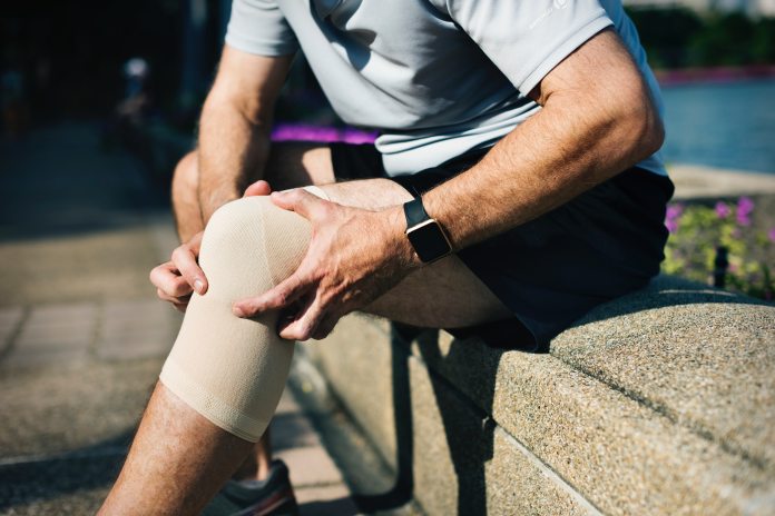 men holding his knee